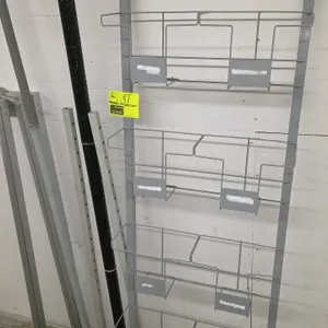 Assorted metal merchandiser parts. Includes a grey metal display frame with four wire literature pockets, vertical metal uprights, a black display pol