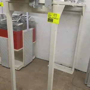 Merchandiser stand. Features cream-finished metal frame construction. Includes top-mounted wire and plastic product divider accessories as shown. Dime