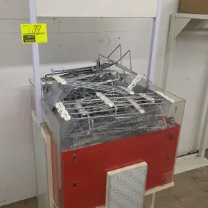 Portable merchandise bin. Features a red and clear acrylic bin topper filled with a large quantity of assorted metal peg hooks, an overhead white sign