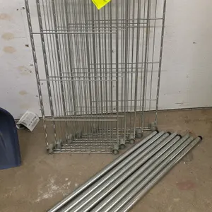 Lot of (5) metal wire shelves and (8) post segments. Features chrome-finished wire construction. Shelves measure 14"x30". Note: Plastic shelf collar c