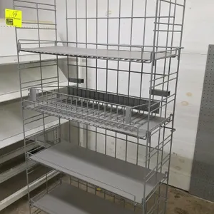 Wire merchandise display shelf. Features a gray metal wire construction with four shelving tiers, including one shelf with an integrated wire basket d