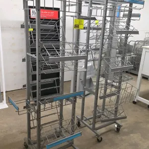 Portable wire merchandiser display rack. Features adjustable wire baskets, wire shelving, hanging hooks, and integrated sign holders. Gray metal frame