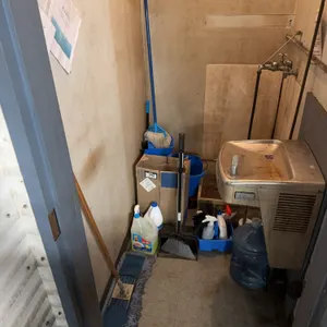 Contents of Janitor Closet including Cleaners, Mop Bucket, Mop, Toilet Paper, etc.