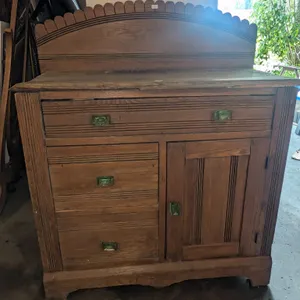 Oak Sideboard with Green Glass Drawer Pulls and Scalloped Backsplash