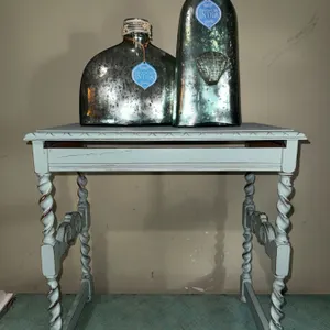 Decorative Glass Bottles and Light Blue Painted Table