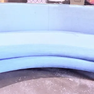 Curved Blue Upholstered Sofa with Tapered Wooden Legs