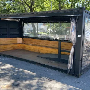 20' BLACK TRANSPORT CONTAINER CONVERTED TO OPEN SIDE PARKLET PATIO STYLE SEATING AREA WITH CLEAR