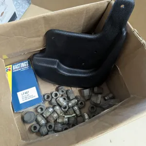 box of vehicle parts, mudflap, oil filter, wheel nuts