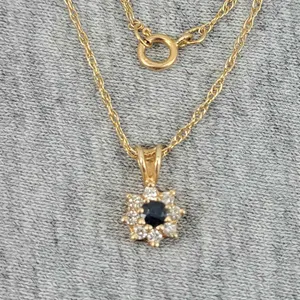 Fine Link 14K Gold 18" chain with a 14K pendant featuring a Blue Stone surrounded by 8 faux diamonds. 1.3g. OB