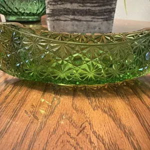 This is a vintage green pressed glass canoe dish