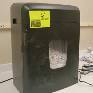 Amazon Basics paper shredder. Features up to 15-sheet capacity, a dedicated slot for credit cards and CDs, and a wastebasket with a transparent viewin