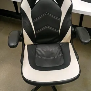 Flux computer chair. Features black and white faux leather upholstery, flip-up padded armrests, and accent stitching. Mounted on a 5-star mobile base 