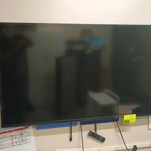 Insignia 56" flat screen TV. Includes wall-mounting bracket and remote control.