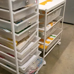 Mobile storage and organizer cart set. Includes one 10-drawer cart with translucent plastic drawers and a white metal frame, and one 3-drawer cart wit