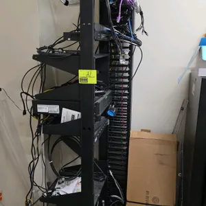 IT rack with network and security equipment. Includes a UNVR-64CH 64-channel Network Video Recorder (S/N: 210235XH4U323B000030), a PSW8-2G PoE switch,