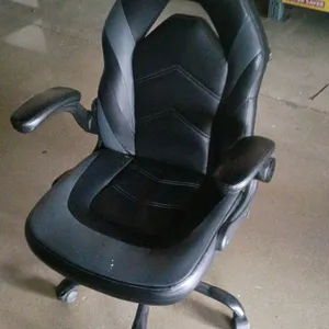 Flux gaming-style computer office chair. Features faux leather upholstery, a contoured high backrest with cutout, padded flip-up armrests, and pneumat