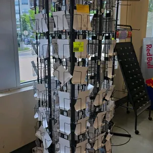 Portable revolving greeting card display rack. Features multi-tier black wire metal pockets for displaying cards and a top sign holder header. 77"H. M