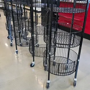 Portable black wire 3-tier round merchandiser rack. Features three wire basket tiers designed for retail product display. Mounted on swivel casters fo