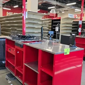 2024 Royston check-out lane stand. Features red metal construction, stainless steel top, cash drawer compartment, and integrated customer-facing wire 