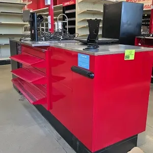 2024 Royston red metal checkout lane stand. Features stainless steel top, three customer-facing wire shelves, device mounting brackets, and cash drawe