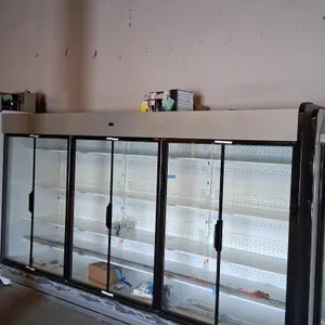 2025 Hussmann IDD5SU12 6-door medium-temp glass door display case lineup. Features adjustable shelving and top-mounted compressor. S/N: MY25L082071. R