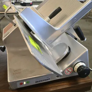 Bizerba GSP manual gravity feed deli slicer. Features a 13" blade, adjustable slice thickness, and anodized aluminum construction. Electrical: 120V, 6