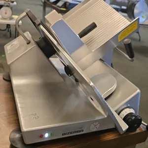 Bizerba GSP H manual gravity feed deli slicer. Features a 13" blade, adjustable slice thickness, and anodized aluminum construction. Electrical: 120V,