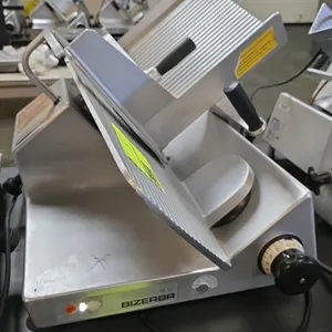 Bizerba SE12 manual gravity feed deli slicer. Features 13" blade, adjustable slice thickness, and anodized aluminum construction. Electrical: 120V, 60