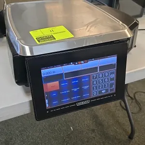 Hobart HTi digital pricing scale. Features a touchscreen user interface, integrated label printer, customer-facing display screen, and a stainless ste