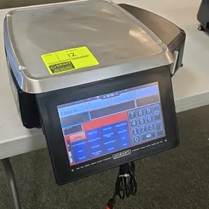 Hobart HTi digital pricing scale. Features a touchscreen user interface, customer display screen, integrated label printer, and stainless steel weighi