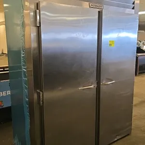Traulsen RR2-1 stainless steel roll-in refrigerator. Features two solid doors, Hobart front branding, and self-contained refrigeration. Includes (2) m
