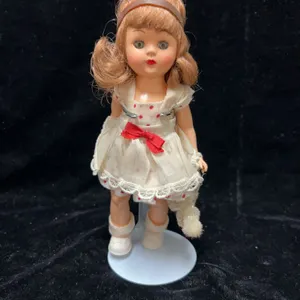 Hard Plastic 8-Inch Doll with Brown Hair, Red Polka Dot Dress, and Plush Dog Accessory, Circa Mid-20