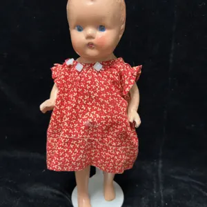 Composition Baby Doll with Red Floral Dress on Kaiser Stand, Early 20th Century American