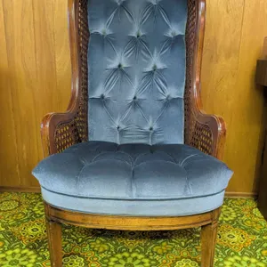 Wood Framed Wingback Chair with Blue Tufted Upholstery and Cane Sides