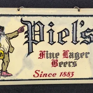 CELLULOID OVER TIN BEER SIGN PIEL'S FINE LAGER BEERS