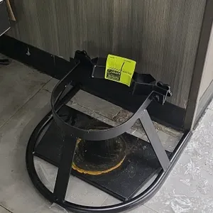 Metal stationary cylinder stand. Features black painted steel construction designed to hold a single pressurized gas cylinder. Includes a floor-standi