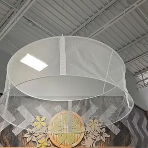 Helium balloon containment net. Features white mesh fabric construction with a circular frame structure designed for ceiling suspension to corral heli