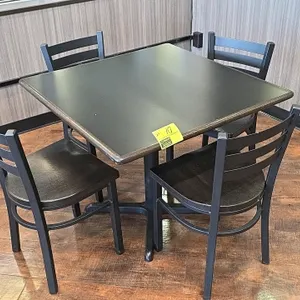 Dining table and chair set. Includes one table measuring 36" x 30" with a black laminate top on a black metal pedestal X-base, and four matching chair