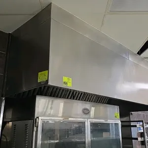 Stainless steel exhaust hood. Features integrated Ansul R-102 wet chemical fire suppression system, stainless steel baffle filters, and integrated lig