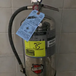 2022 Buckeye WC-6L 6-liter wet chemical Class K fire extinguisher. Features a stainless steel cylinder with discharge hose and nozzle. Rated Class 1-A