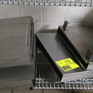 Stainless steel knife holder. Features durable stainless steel construction. Equipped with rear mounting brackets and a removable slotted plastic inse