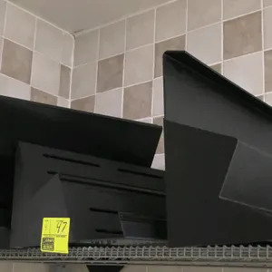 Poly two-tier display riser. Features a black plastic construction with a tiered design, ideal for retail or food service display cases. 2'L. Note: Wi