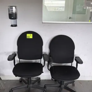 Office chair. Features black fabric upholstered seat and back, adjustable armrests, and pneumatic height adjustment. Mounted on a black 5-star swivel 
