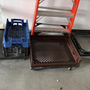 Assorted 4-wheel dolly lot. Includes (3) plastic dollies and (1) wooden flatbed dolly. Outfitted with swivel casters. Includes plastic bakery crates, 