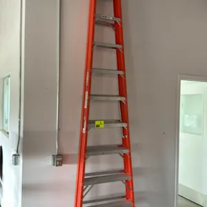 Werner 10' fiberglass foldable step ladder. Features orange fiberglass rails, slip-resistant aluminum steps, and a black plastic top cap with tool slo
