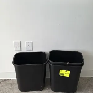 Poly trash can. Features a black rectangular plastic construction with an open top and integrated rim. 15".