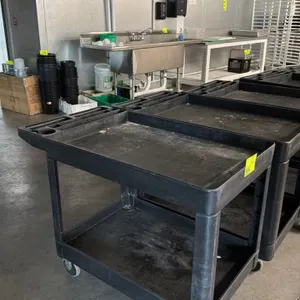 Unbranded 2-tier poly utility cart. Features durable black plastic construction with two tub-style shelves and a molded push handle containing integra