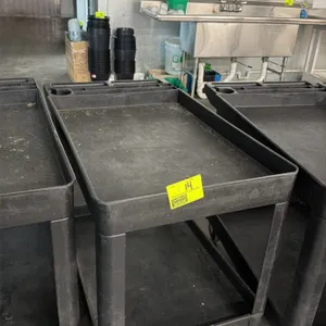Poly 2-tier utility cart. Features molded plastic construction with top shelf tool compartments, integrated cup holder, and a molded handle. 3'L. Moun