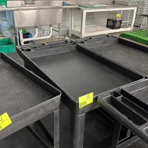 Poly 2-tier utility cart. Features durable black plastic construction, deep well shelves with raised lip edges, and a molded handle with integrated to