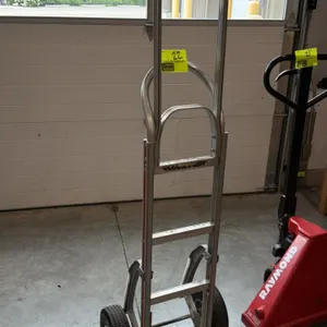 Magliner 2-wheel hand truck. Features lightweight aluminum construction, a loop handle, and a metal nose plate. Mounted on two pneumatic tires. Note: 